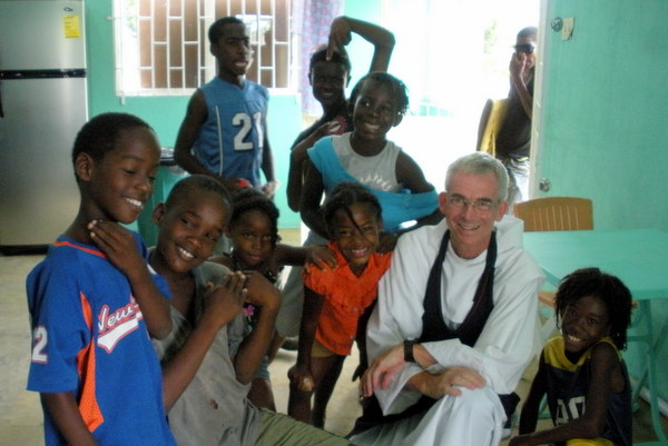 Fr. Jim Bok, OFM, surrounded by the St. Anthony 'Kitchen Kids'
